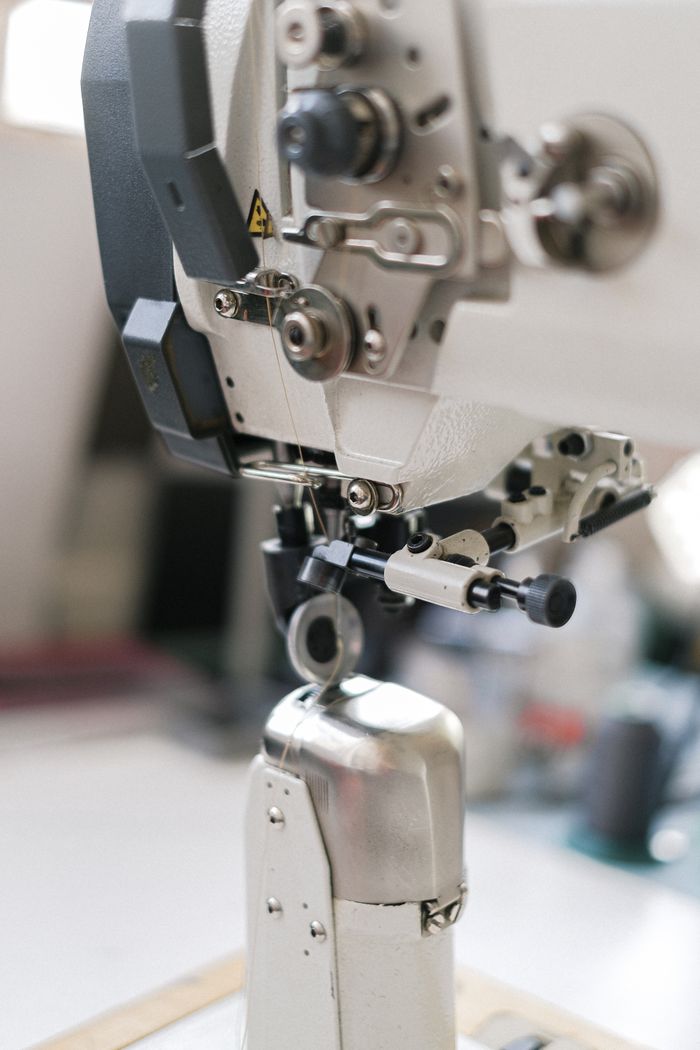 services-06 Detailed view of sewing machine components, showcasing precision and industrial design.